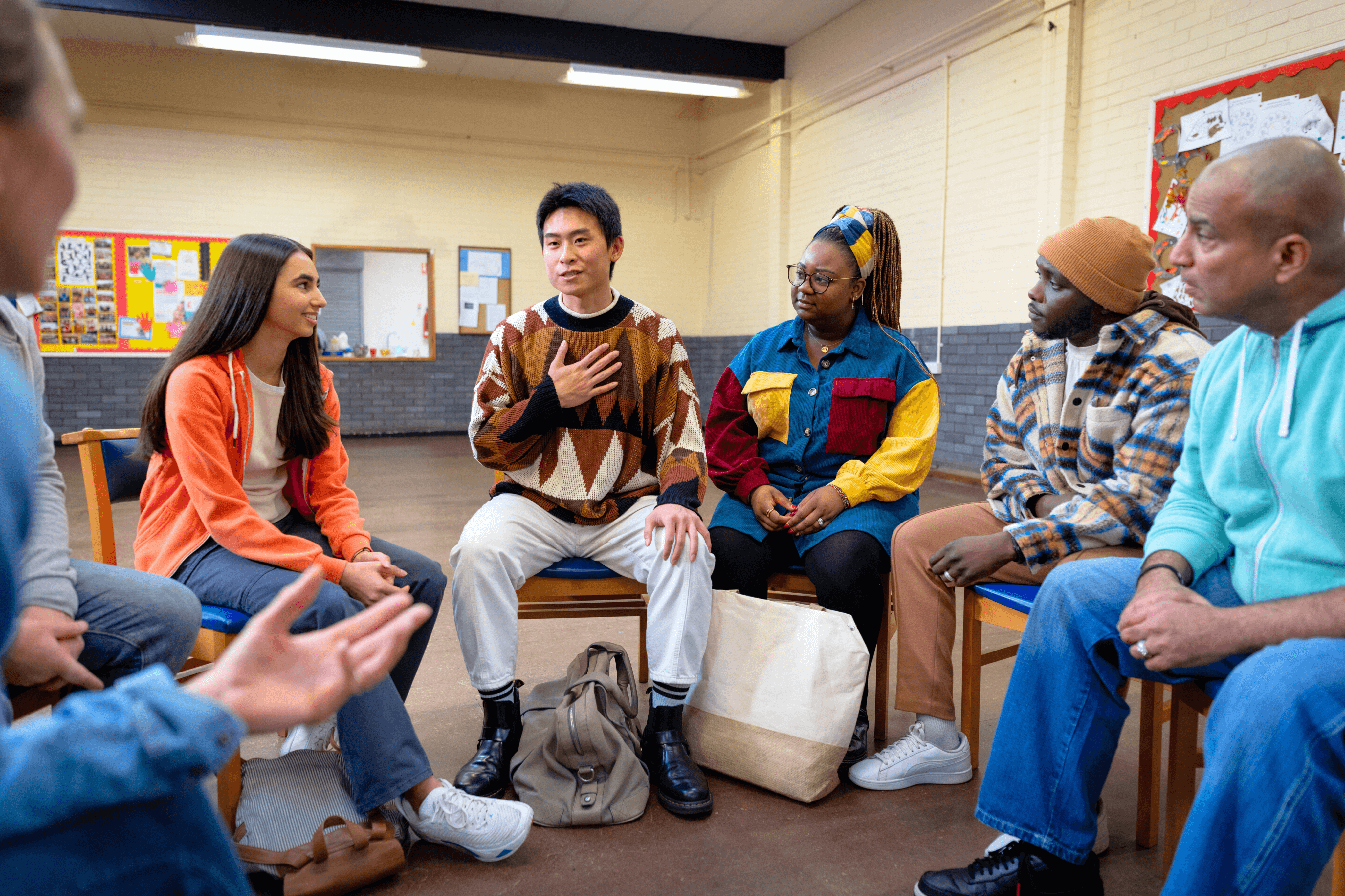 man shares in a group therapy session at a residential mental health program