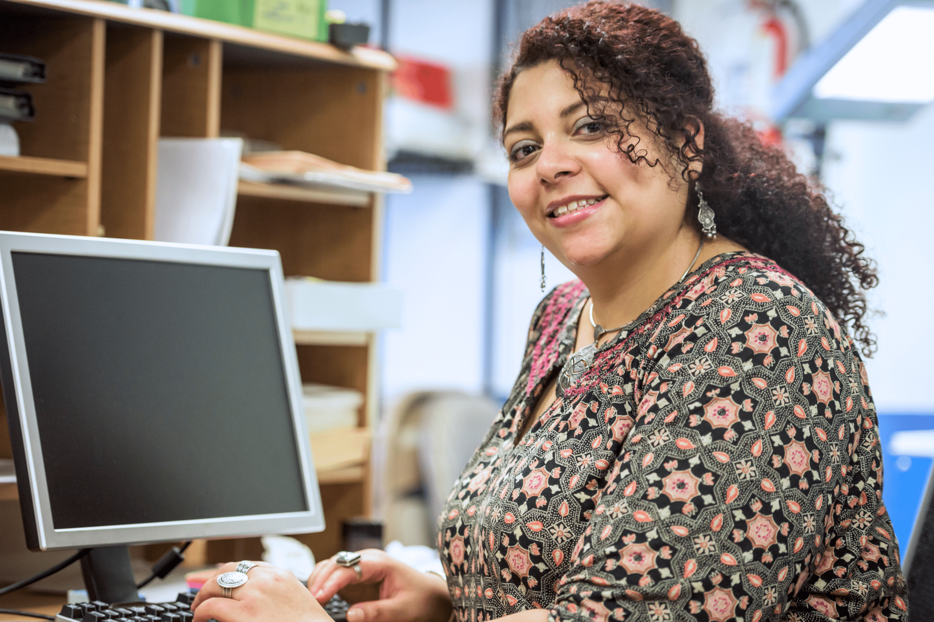 A woman sits at the desk of RHA's walk-in behavioral health facility