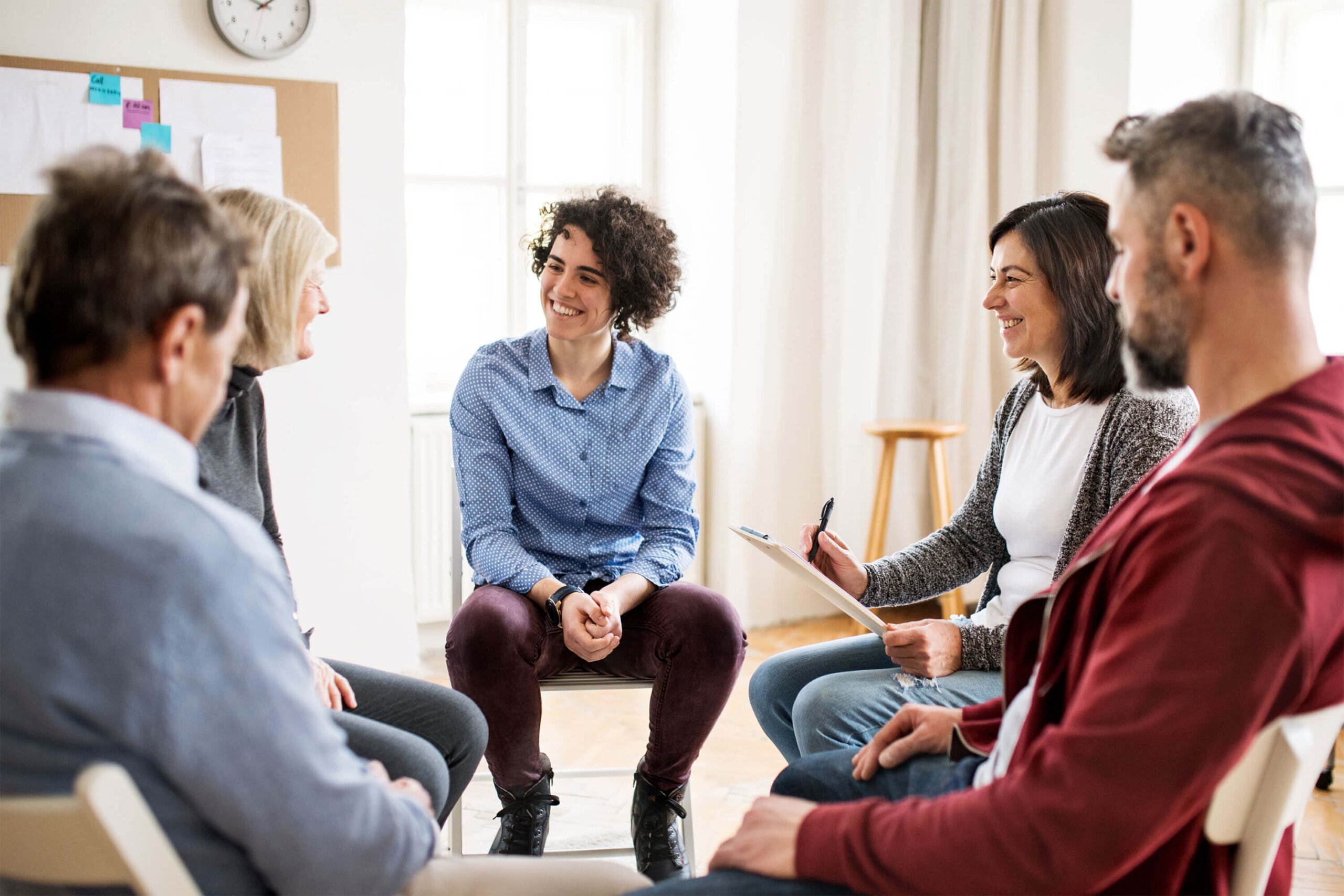 a group behavioral health therapy session meets in a sunny room