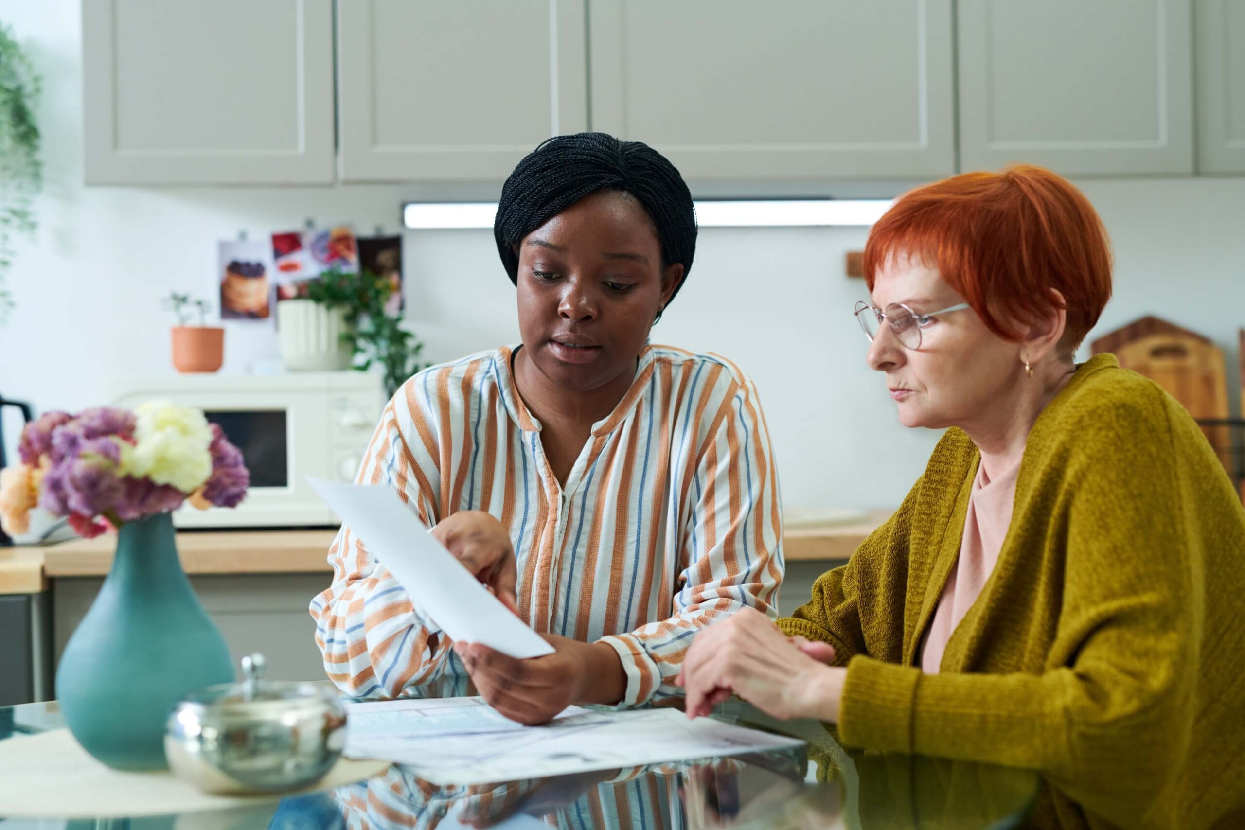 A healthcare management professional assists an older woman with I/DD in her home