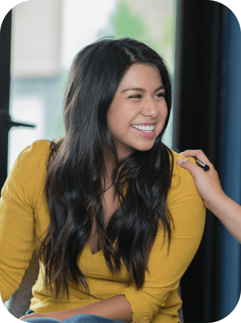 woman smiling during group therapy session at a rehab center