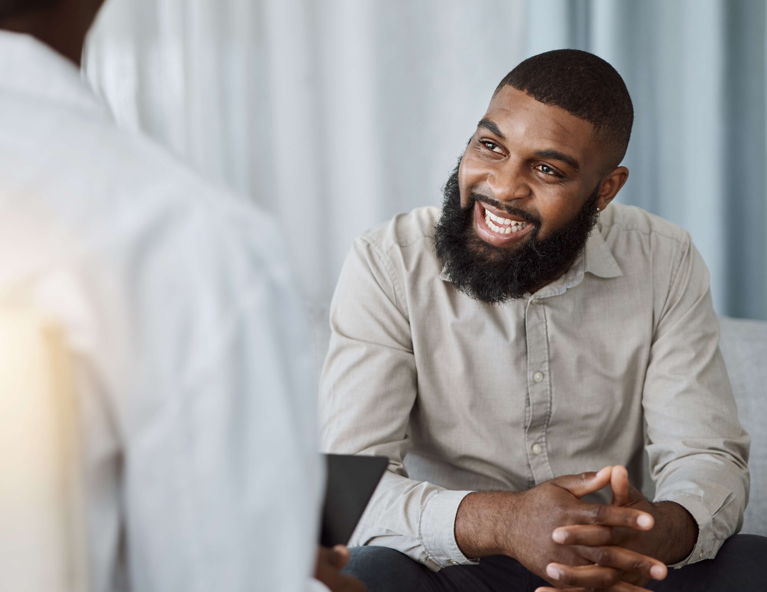 man smiling in therapy session