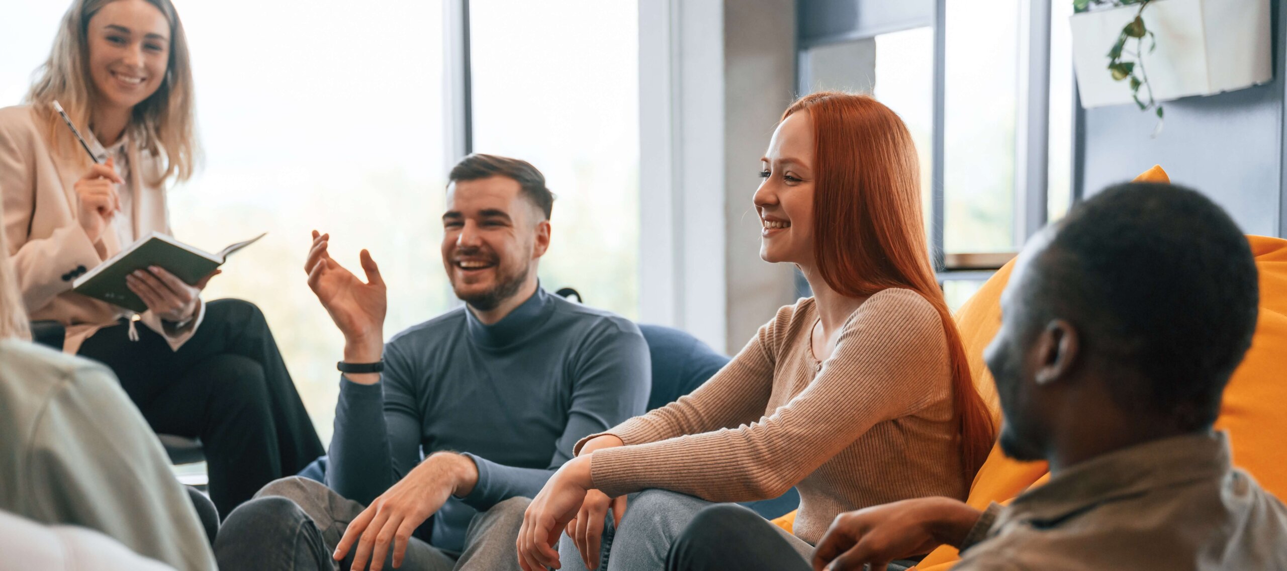 People in team therapy smiling